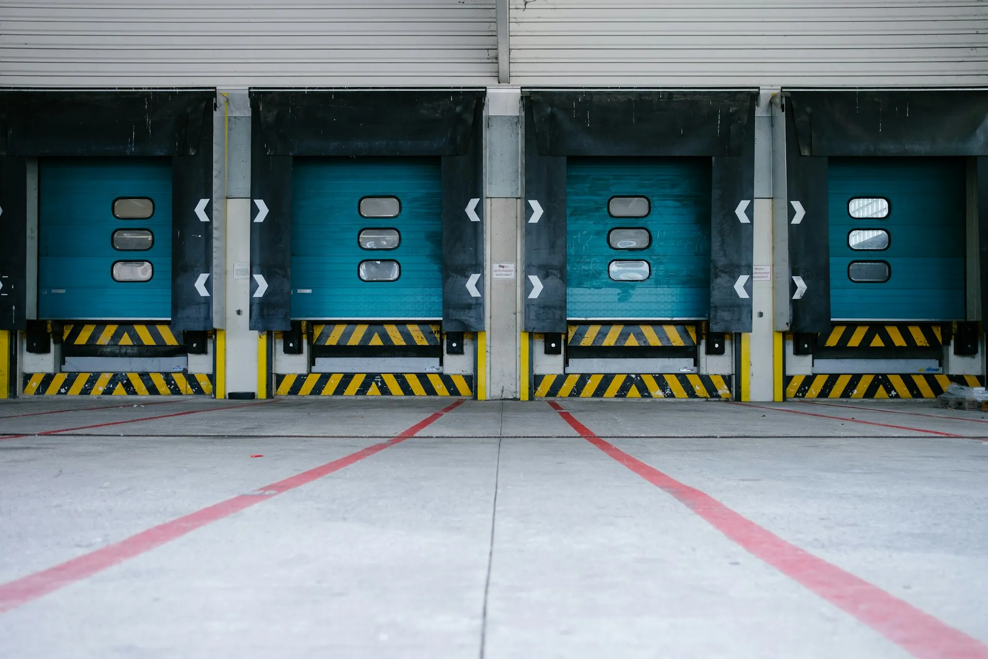 Row of blue commercial loading dock doors