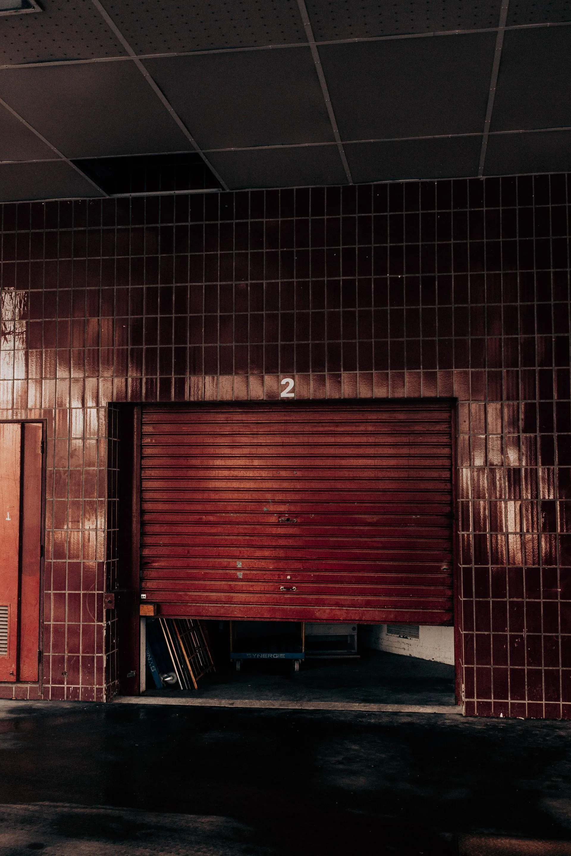 Red brick industrial building with roll-up doors