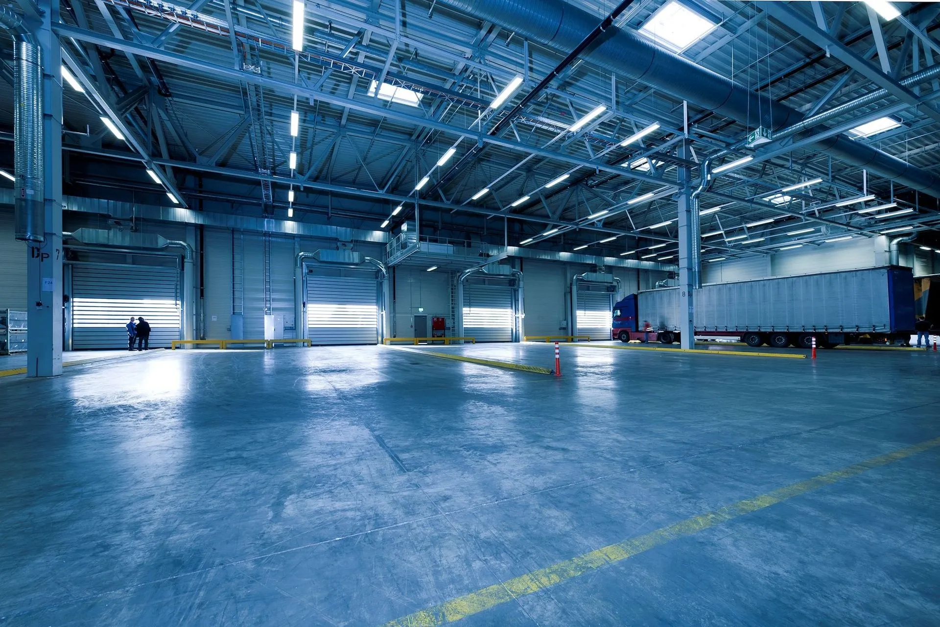 Large industrial warehouse with open loading doors