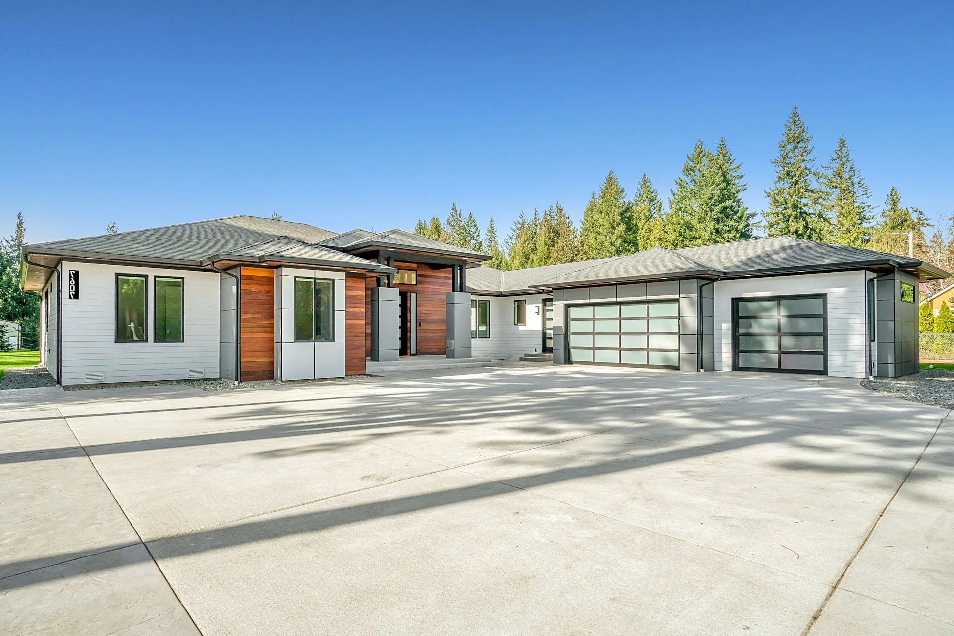 Modern home with two glass-panel garage doors