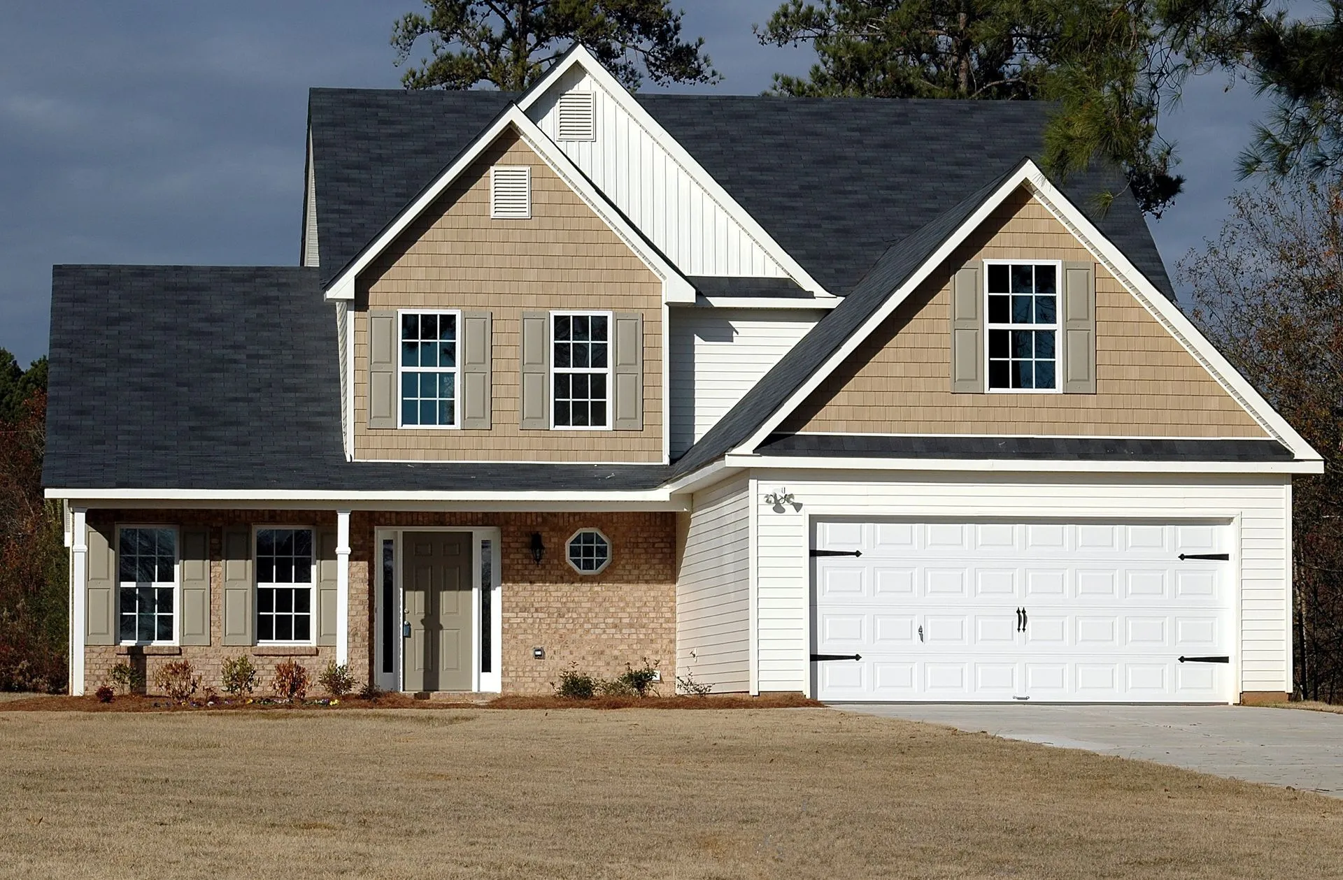 White residential garage door with decorative hardware
